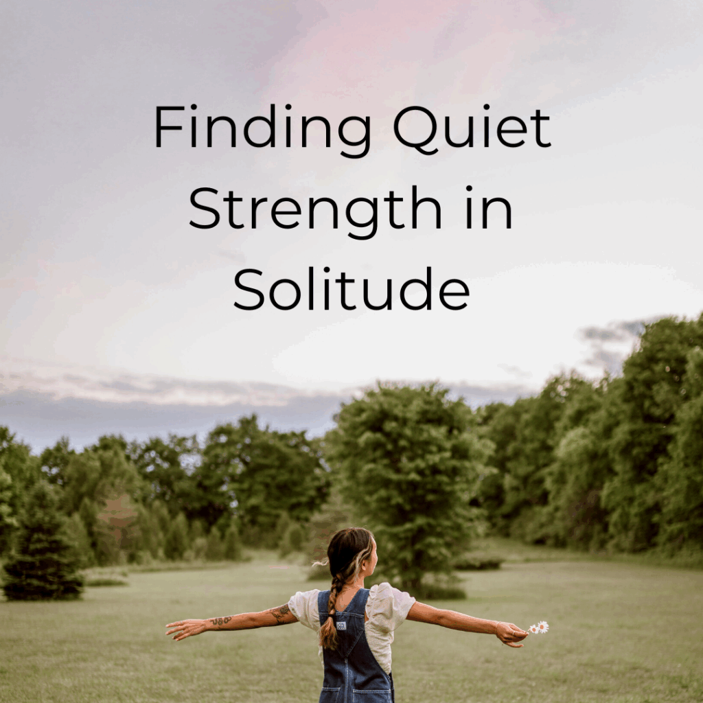 A woman standing with her arms wide open looking out onto a tree covered hill. The words "Finding Strength in Solitude"
