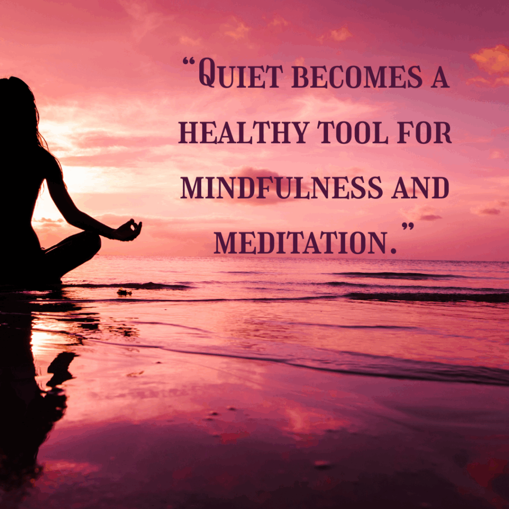 On a photo of a women in a seated on a beach in a yoga pose against a dark pink sunset, the words "Quiet becomes a healthy took for mindfulness and meditation."