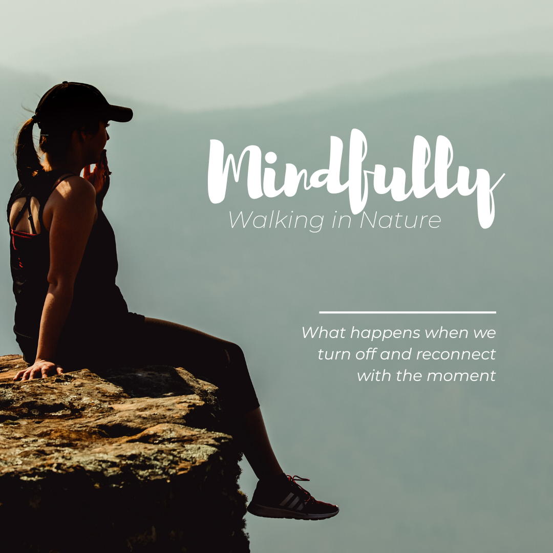 A woman sitting on the edge of a cliff looking out at the sky. the words Mindfully walking in nature - What happens when we turn off and reconnect with the moment.
