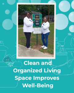 A photo of smiling black women wearing matching 988 shirts standing in front of a sign that says Tidy Room Tidy Mind and the words Clean and Organized Living Space improves Well-Being